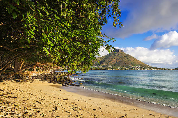 Rocky and sandy shore in Tamarin Bay, Mauritius stock photo