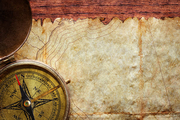 istock Compass Sitting On A Map MAde Of Parchment 506238984