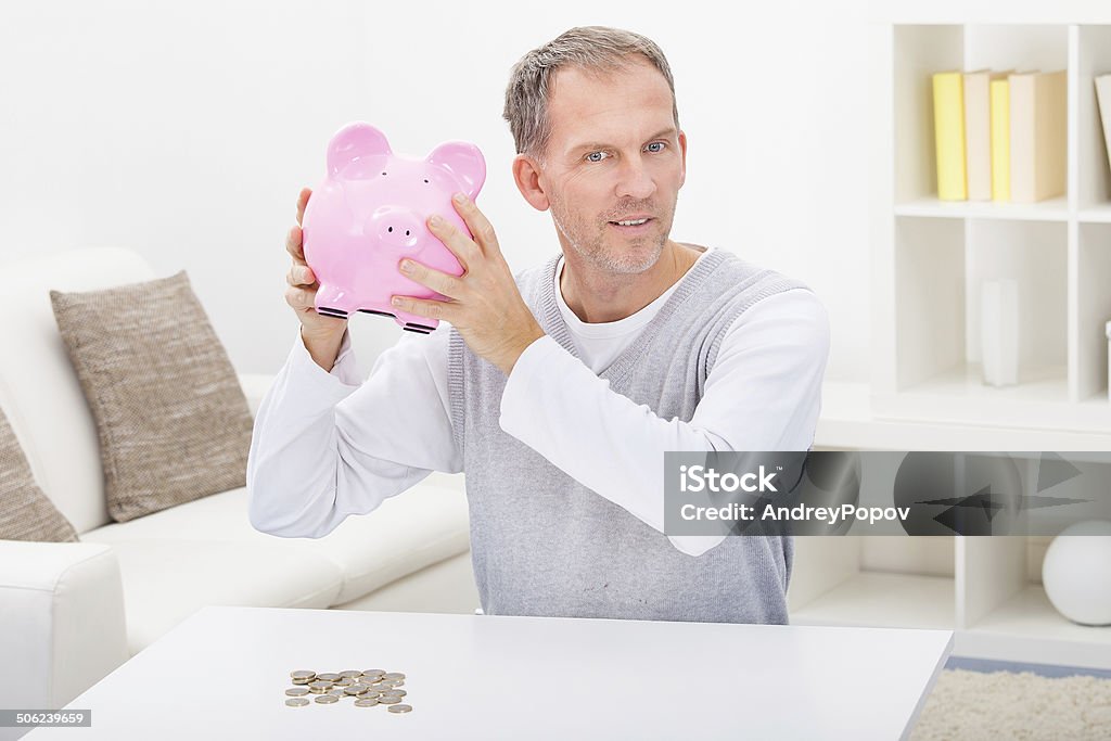 Man Holding Piggybank Portrait Of A Mature Man Holding Piggybank Adult Stock Photo