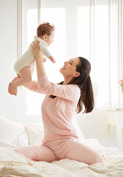 istock mother playing with her baby 506241140