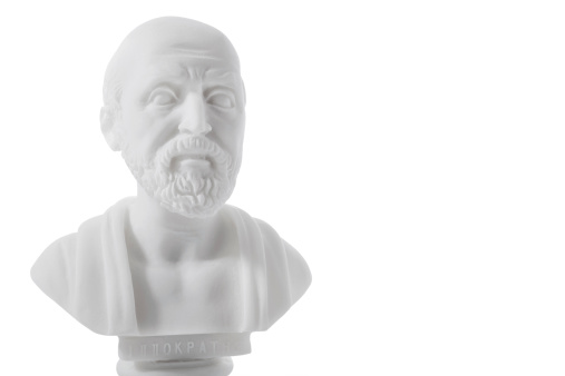Hippocrates (460-380 B.C.E.) Ancient Greek physician, traditionally regarded as the father of medicine. Sculpture isolated on white background