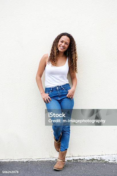 Smiling Young Woman Posing Outdoors Stock Photo - Download Image Now - Women, Full Length, Leaning