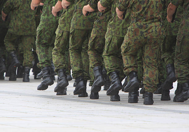 Soldiers march in formation stock photo