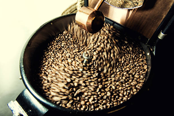 istock Freshly roasted coffee beans rotated in spinning cooler professional machine. 506243940