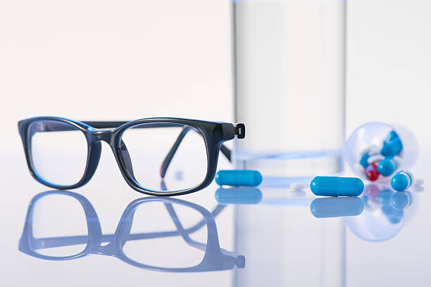 istock Glasses, pills and water glass are on the surface 506244338