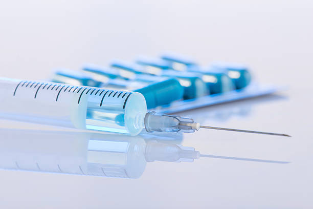 istock Pack of pills and syringe are on the surface 506244442