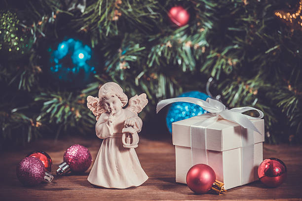 istock Wooden statue at christmas background with gift box, toned 506245014