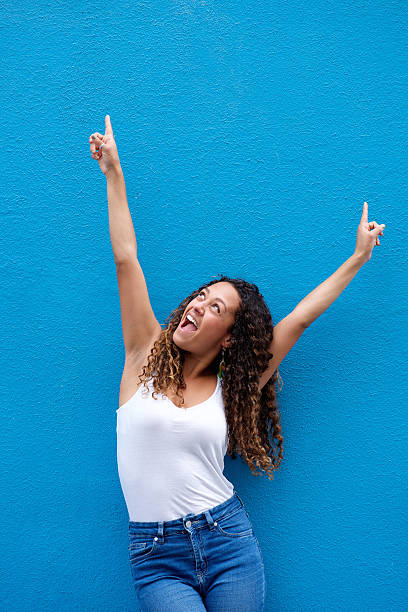 istock Excited young woman with arms raised 506245912