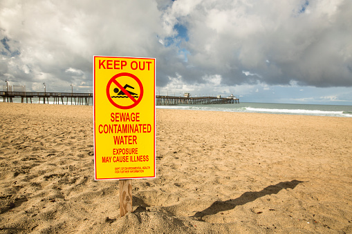 Pollution sewage danger marker on the Ocean shore