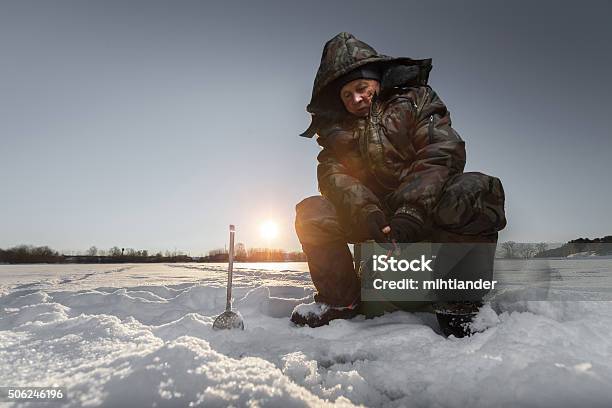 Fisherman On A Winter Lake Stock Photo - Download Image Now - Ice Fishing, Pond, Senior Adult