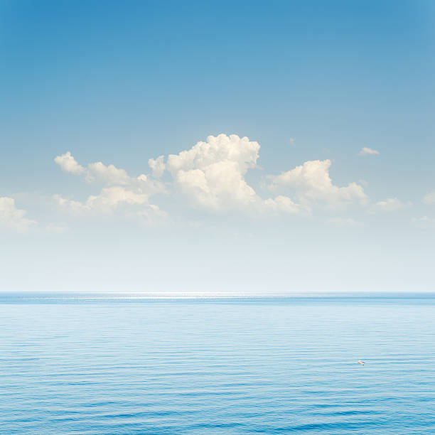 istock blue sea and sky with clouds over it 506246298
