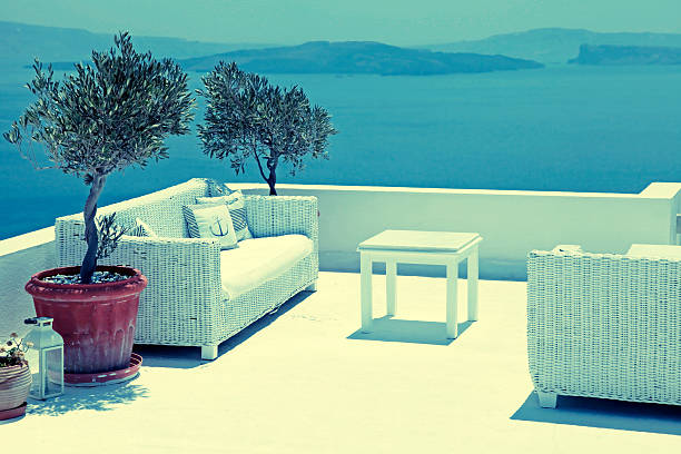 Santorini, Greece - July 29, 2015: Beautiful relax sea view terrace with white sofa, Santorini island, Greece. Vintage toned image, selective focus