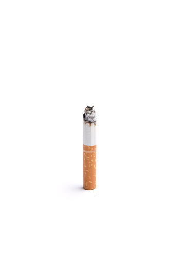 A burning cigarette butt on a white background