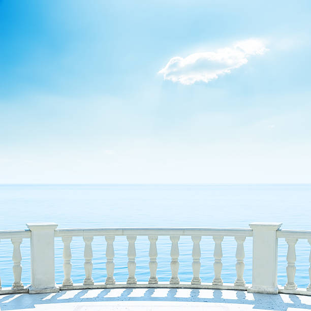 istock white balcony near sea and blue sky with clouds 506246700