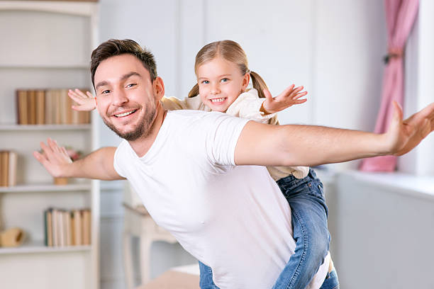 istock Vivacious father and daughter laying together 506247052