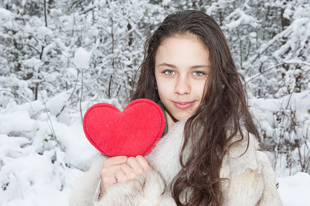 istock girl holding a toy heart 506247734