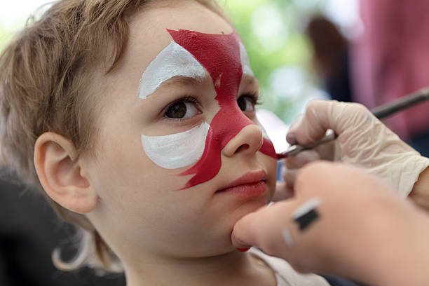 istock Person painting boy face 506247894