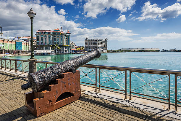 Old cannon on the promenade at Caudan Waterfront, Port Louis Old cannon on the promenade at Caudan Waterfront, Port Louis, Mauritius, Indian Ocean artillery photos stock pictures, royalty-free photos & images