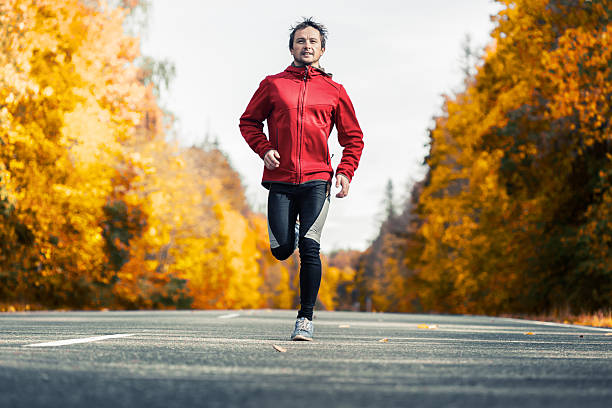 istock Runner on the autumn road 506251102