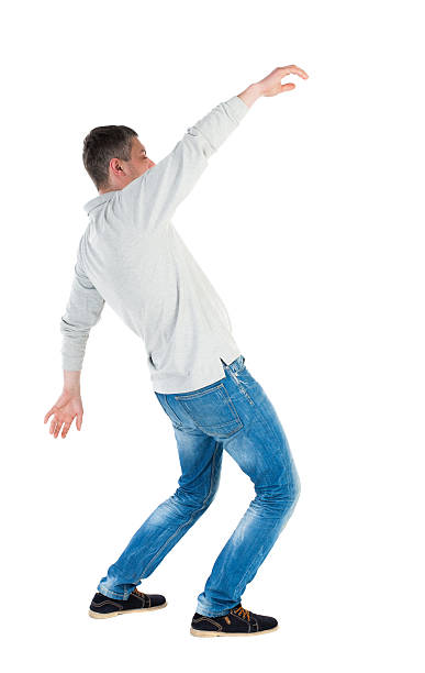 istock Back view man Balances waving his arms. 506251370