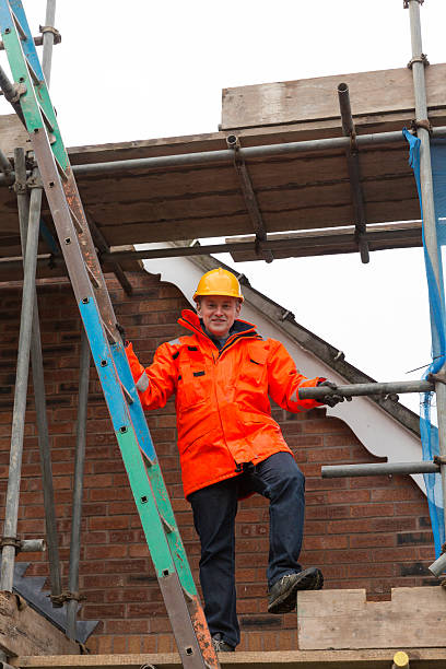 istock Male builder working at house site in UK 506251926