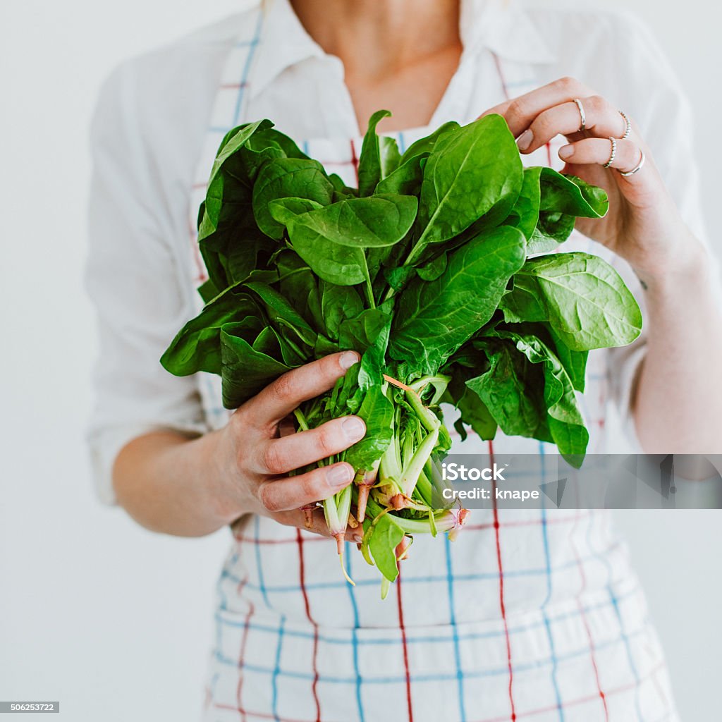 Young woman with fresh spinach Spinach Stock Photo
