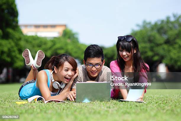 Happy College Students Using Computer Stock Photo - Download Image Now - Adult, Business, Business Person