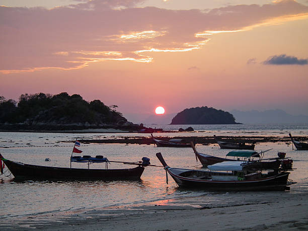 istock Traditional thai boats at sunrise beach. 506283967