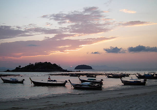 istock Traditional thai boats at sunrise beach. 506283969