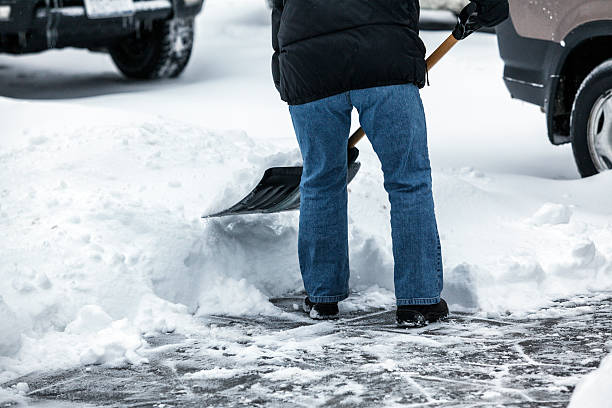 istock Person Shoveling Sidewalk Snow Wearing Winter Jacket 506284900