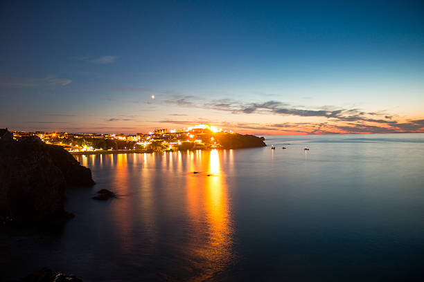 istock Newquay Beach Sunset - lights reflection on water 506285506
