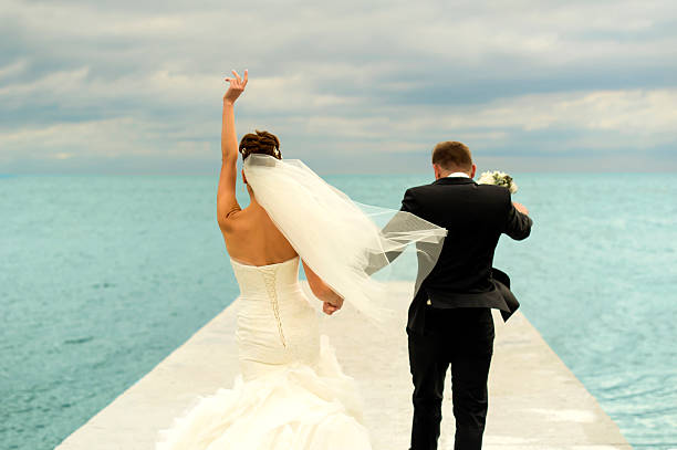 istock Nice newlyweds are walking on the pier. 506285574