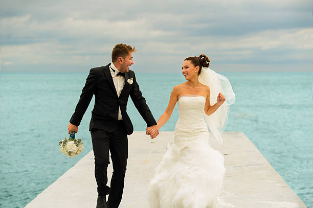 istock The newlyweds are running on the pier. 506285642
