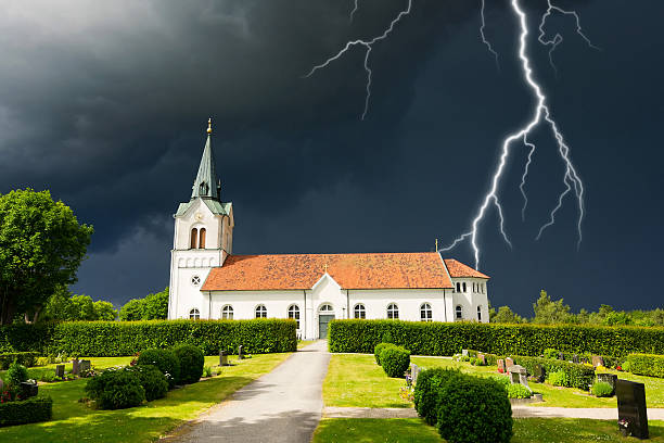 istock Stormy clouds over Swedish church 506285677