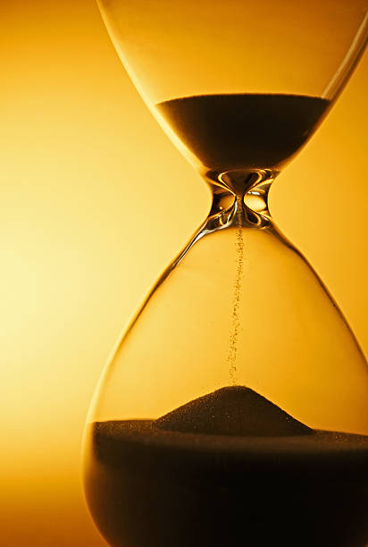 istock Sand passing through the bulbs of an hourglass 506286033