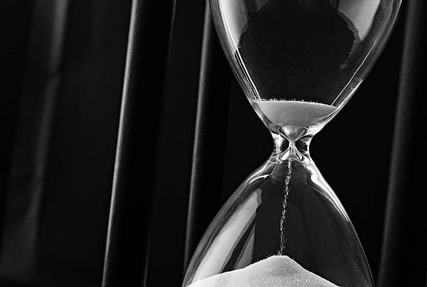 istock Sand running through the bulbs of an hourglass 506286039