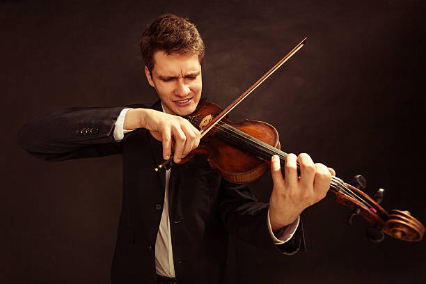 istock Man violinist playing violin. Classical music art 506286371