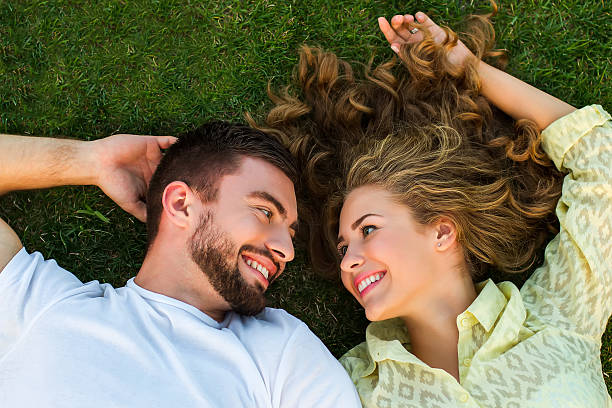 istock Happy couple lying on the grass. 506287974