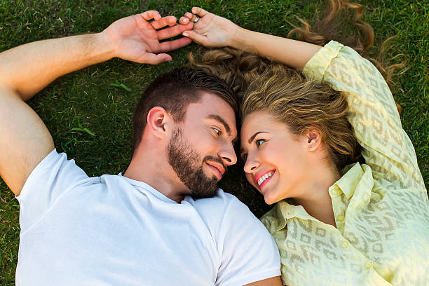istock Cute guy and girl lie on the grass. 506288006
