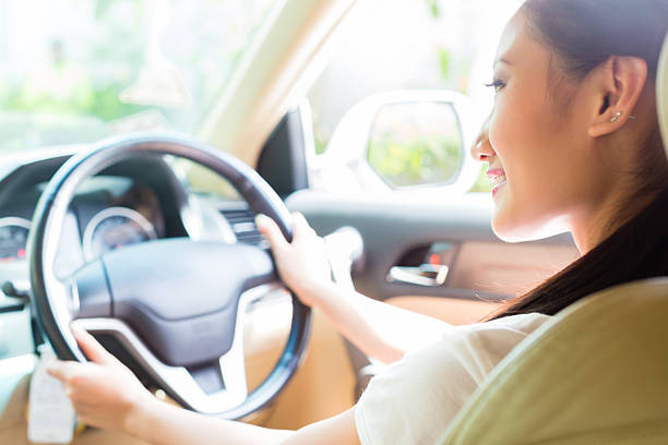 istock Asian woman driving new car 506288968