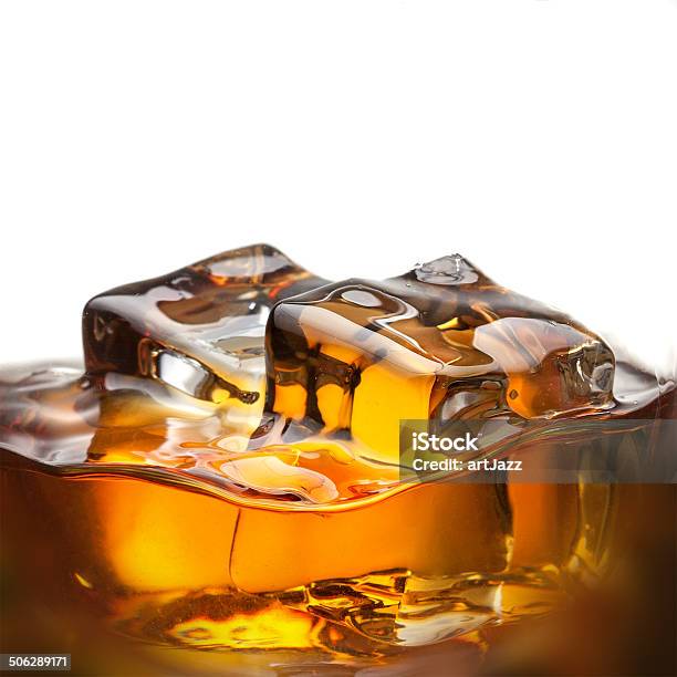 Splash Of Whiskey With Ice In Glass Isolated On White Stock Photo - Download Image Now