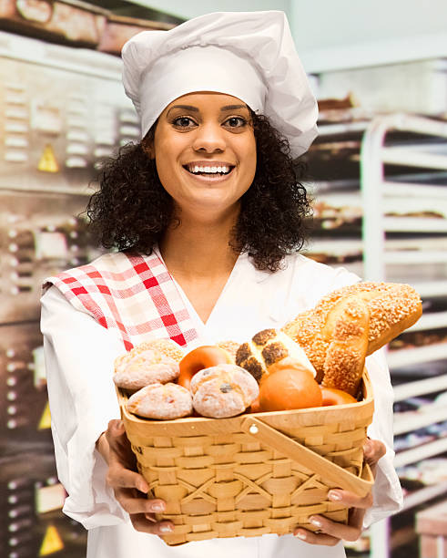 istock Smiling female baker in bakery with basket 506291492