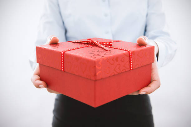 istock Businesswoman holding gift box 506292460
