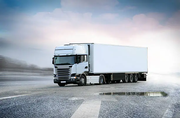 White Lorry big truck on grunge road with sky in background, isolated with clipping path