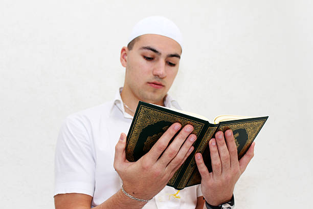 istock Young Muslim Man Reading The Koran 506294164