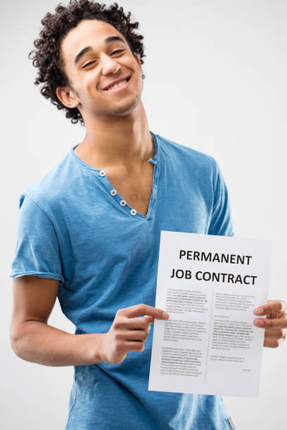 istock permanent job contract shown by a young man 506294750