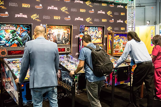 Games People Play  Las Vegas, NV - Jan. 8, 2016: Visitors to the 2016 Consumer Electronics Show (CES) test their skills on a new generation of pinball games in Las Vegas. pinball machine stock pictures, royalty-free photos & images