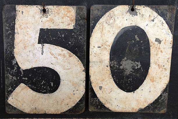 The number 50 on an old cricket scoreboard stock photo