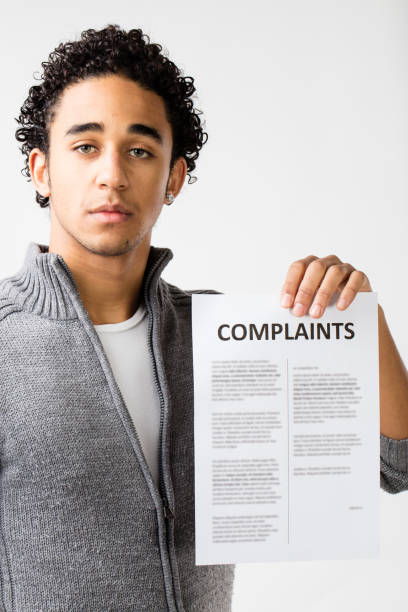 istock young man holding complaints report 506296218