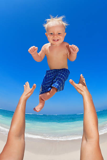 istock Father throwing up in the air a happy child 506296834